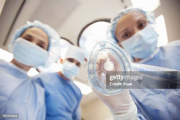 surgeons performing operation - anesthesia mask foto e immagini stock