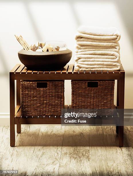 table with towels and bowl - side table stock pictures, royalty-free photos & images