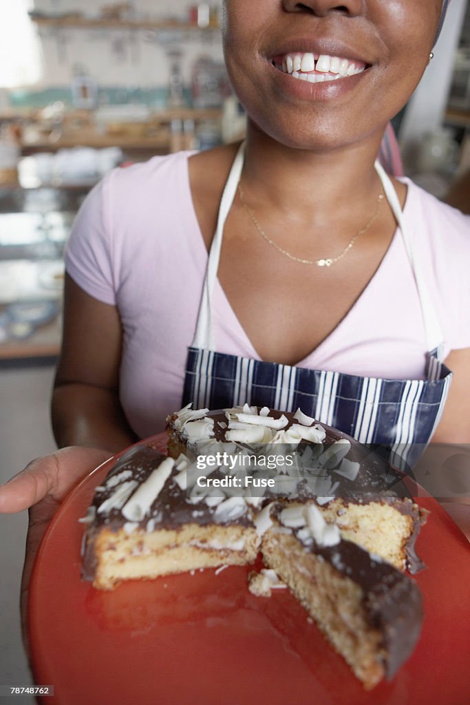 Baker Holding Chocolate Cake