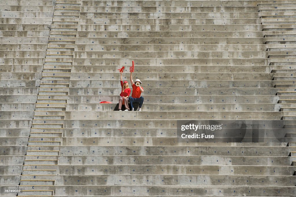 Young Couple Sitting Alone in Bleachers