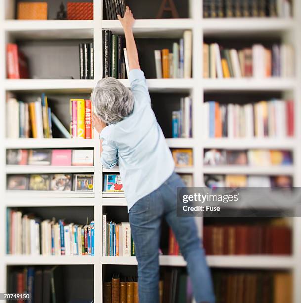 Reaching Books Reaching For Shelf Photos and Premium High Res Pictures - Getty Images