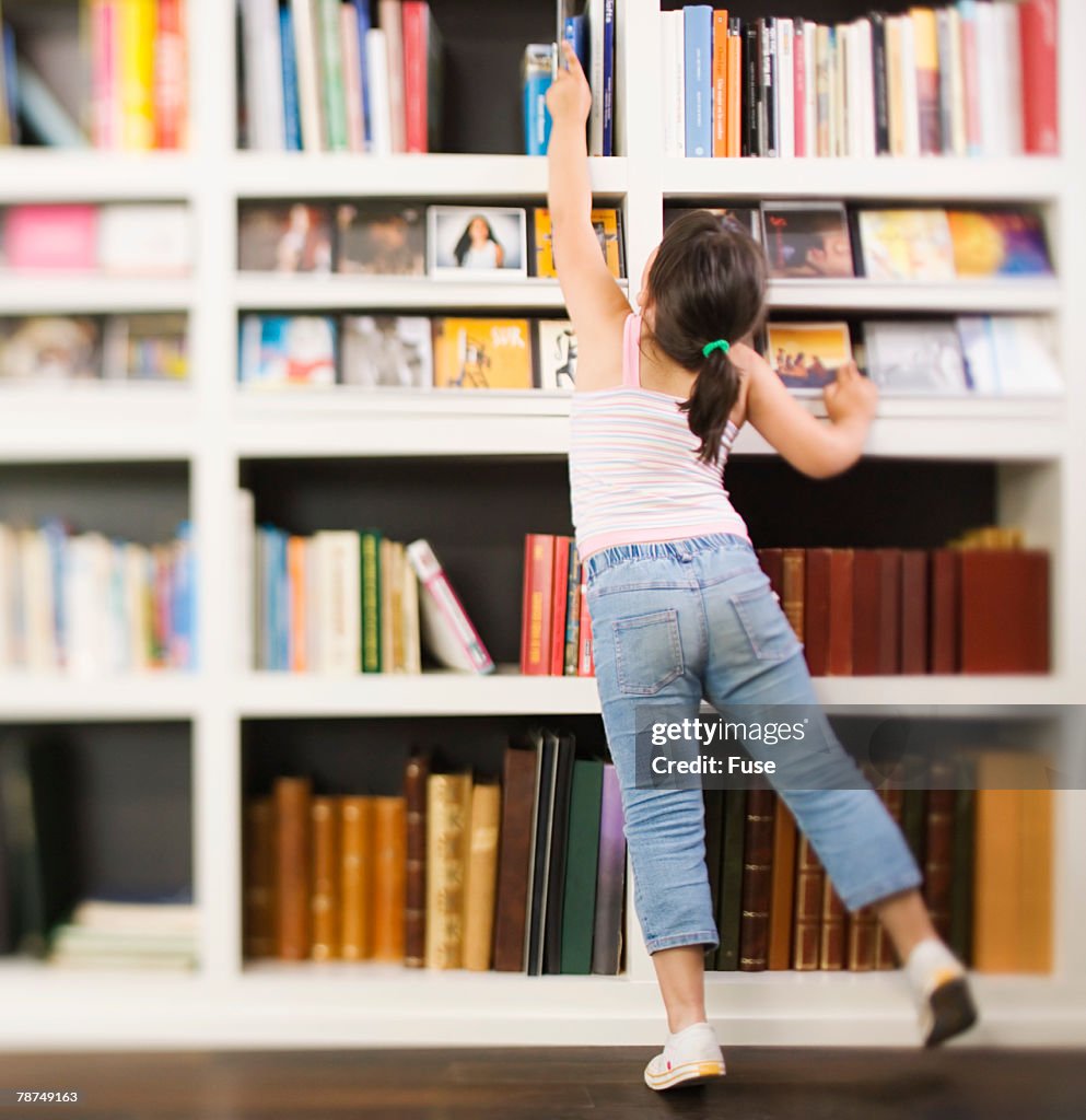Reaching Books Girl Reaching For A Book High-Res Stock Photo - Getty Images
