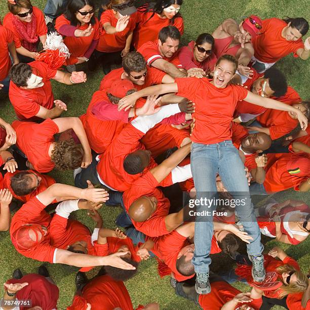 young woman crowd surfing - crowd surfing stock-fotos und bilder