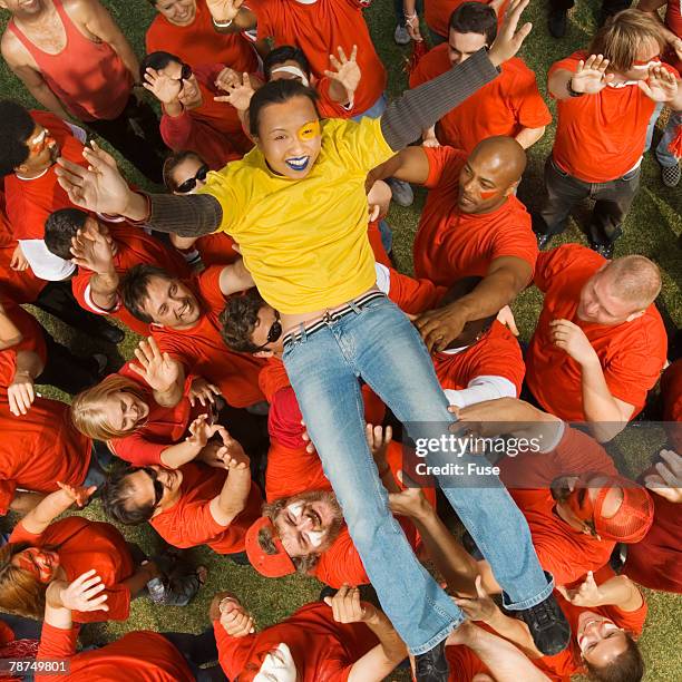 young woman crowd surfing - crowd surfing stock pictures, royalty-free photos & images