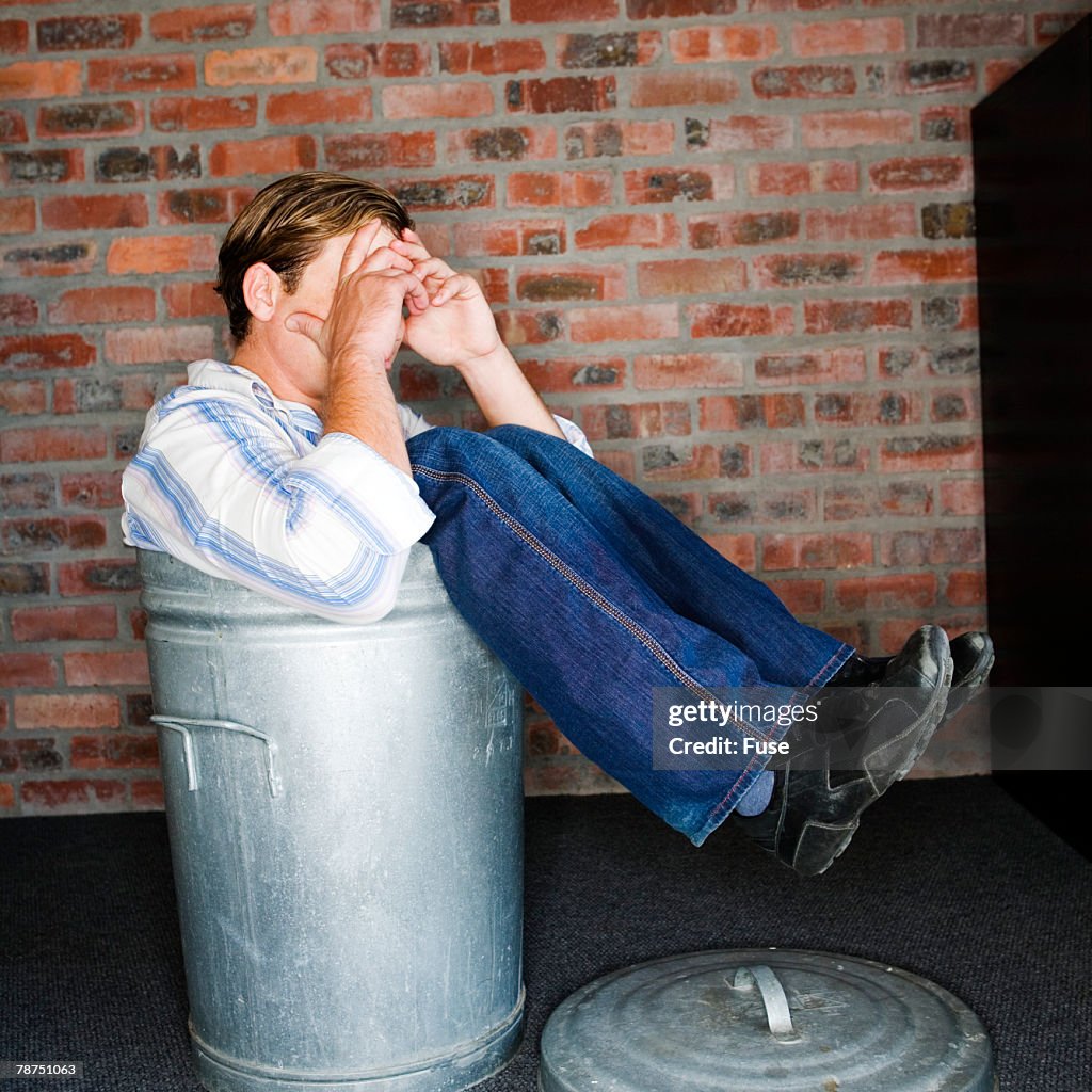 Businessman in Trash Can