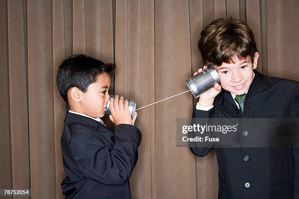 young businessmen using tin can phone - tin eye stock pictures, royalty-free photos & images