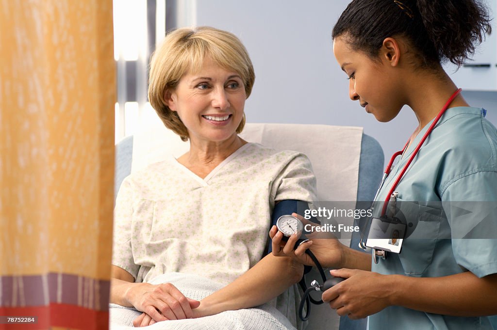 Nurse Taking Patient s Blood Pressure