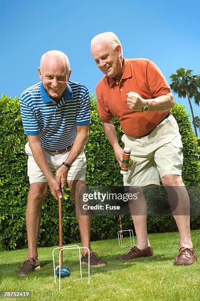 two senior men playing croquet - croquet fotografías e imágenes de stock