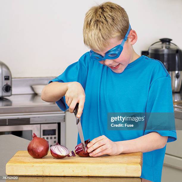 boy chopping onion and wearing goggles - cutting red onion stock pictures, royalty-free photos & images