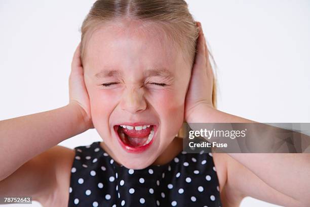 girl with hands over ears screaming - hands over ears stock pictures, royalty-free photos & images