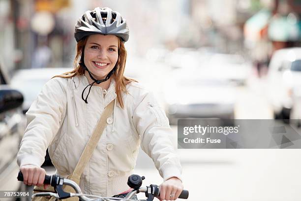 woman on bicycle - casco fotografías e imágenes de stock