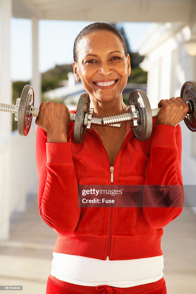 Smiling Woman Lifting Weights