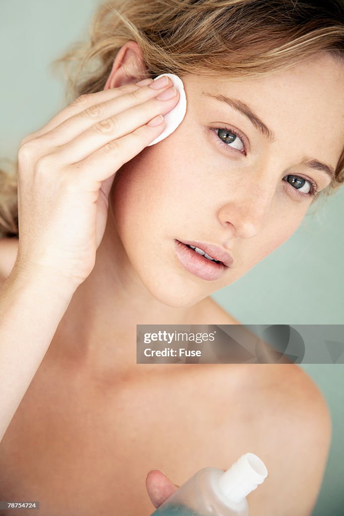 Young Woman Using Facial Cleanser