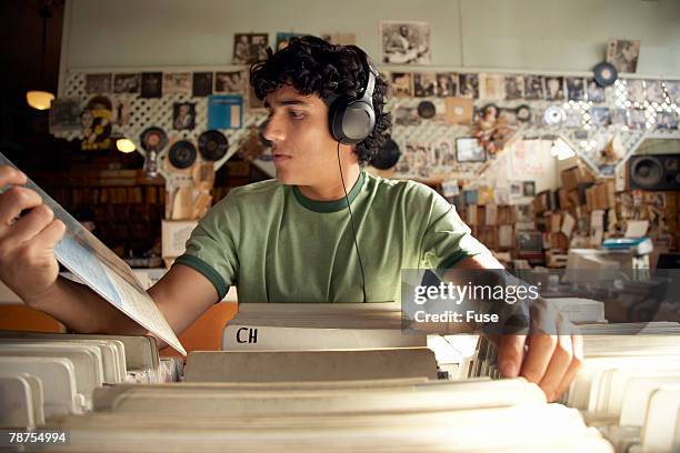 man in record store - headphones in store stock pictures, royalty-free photos & images