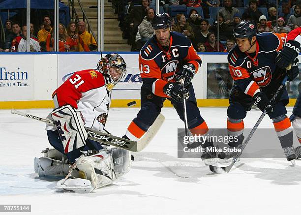 Goaltender Craig Anderson of the Florida Panthers makes a stick save against Bill Guerin and Richard Park of the New York Islanders at Nassau...