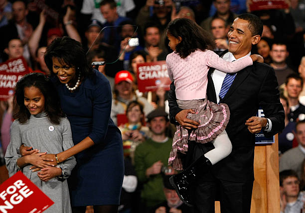 Democratic presidential candidate Sen. Barack Obama holds his youngest daughter Sasha with his wife Michelle and daughter Malia while thanking...
