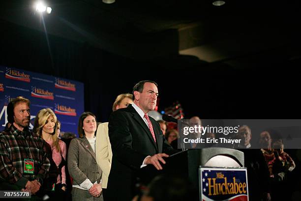 Republican presidential candidate and former Arkansas Gov. Mike Huckabee speaks to supporters during his caucus night event at the Embassy Suites...