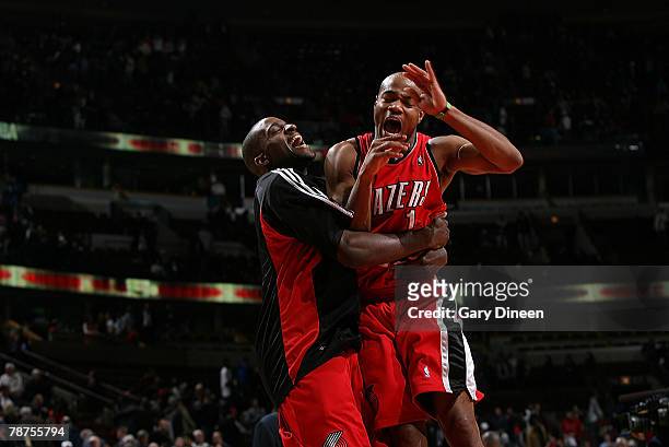 Jarrett Jack and Martell Webster of the Portland Trail Blazers celebrate following their team's double-overtime win over the Chicago Bulls at the...