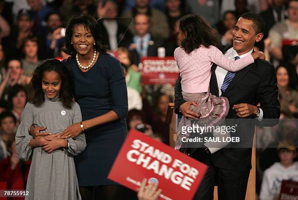 Democratic presidential hopeful and Illinois Senator Barack Obama stands on stage with his wife Michelle and their daughters Sasha and Malia during...