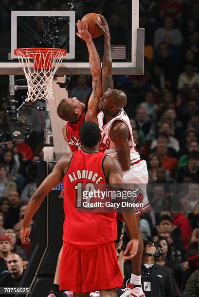 Joel Przybilla of the Portland Trail Blazers fouls Joe Smith of the Chicago Bulls during a dunk attempt at the United Center January 3, 2008 in...