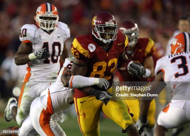 Fred Davis of the USC Trojans runs for yardage after a reception in the second half against Martez Wilson of the Illinois Fighting Illini in the...