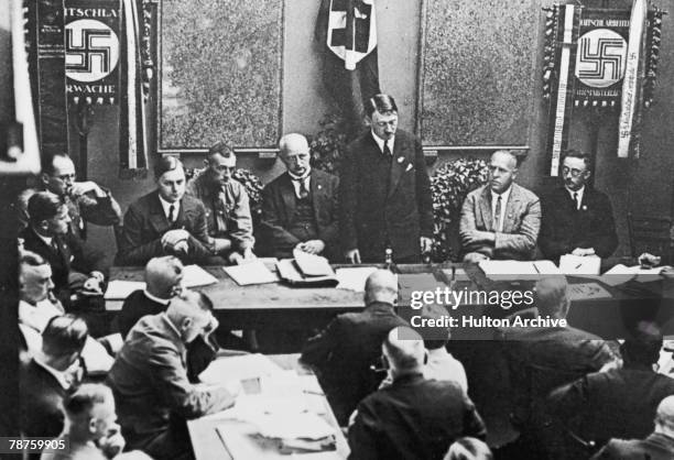 German Nazi leader Adolf Hitler at a party meeting in Munich, circa 1925. Also present are Alfred Rosenberg , Gregor Strasser and Heinrich Himmler .