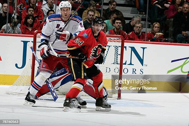 Craig Conroy of the Calgary Flames sets a screen in front of the net while defended by Marek Malik of the New York Rangers on January 2, 2008 at...
