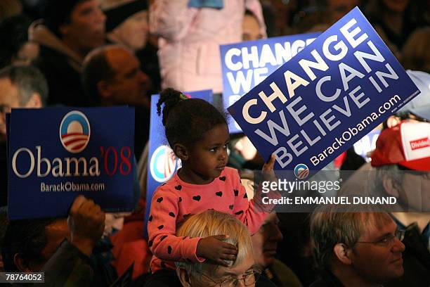 Young girl holds a poster supporting US presidential candidate Barack Obama during a campaign rally in Portsmouth, New Hampshire 04 January 2008....