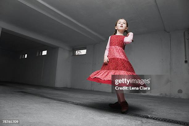 a young girl wearing a red dress - red dress child stock pictures, royalty-free photos & images