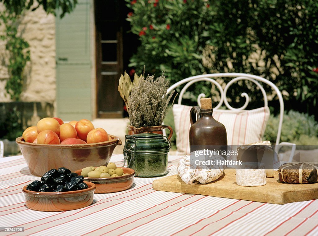 An outdoor table set with wine and appetizers