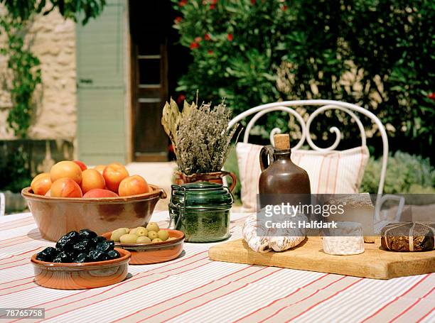 an outdoor table set with wine and appetizers - french garden imagens e fotografias de stock