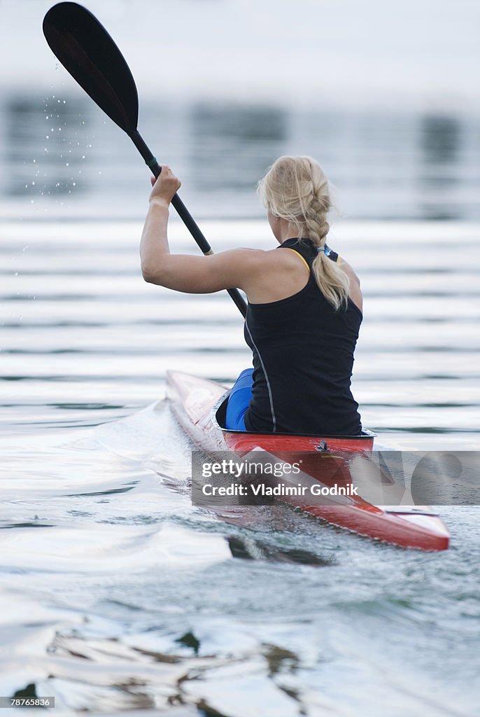 Rear view of a woman kayaking