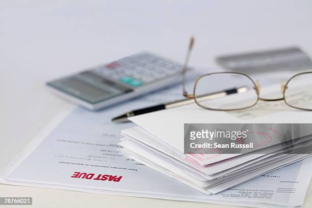 stack of envelopes with pen, calculator, glasses and credit card - credit card and stapel stockfoto's en -beelden