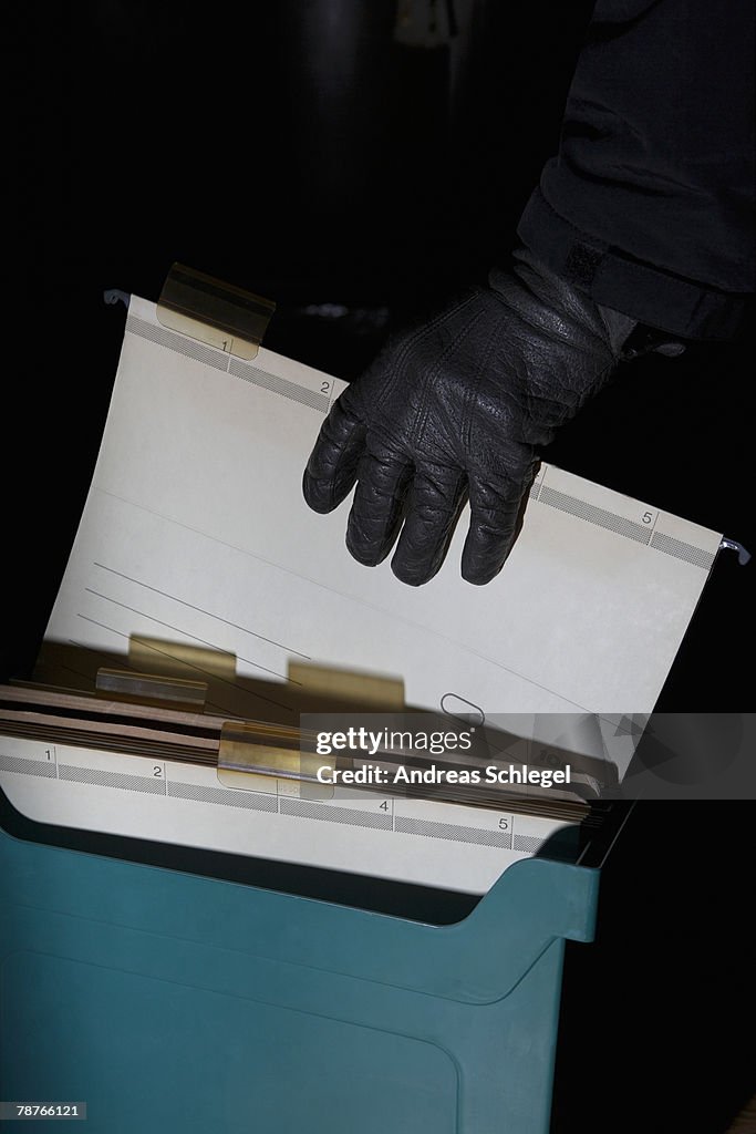 Detail of a hand with a leather glove holding a file