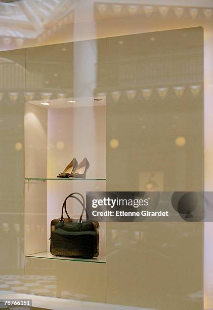 a pair of shoes and a handbag in a shop window display - luxury handbag stock pictures, royalty-free photos & images