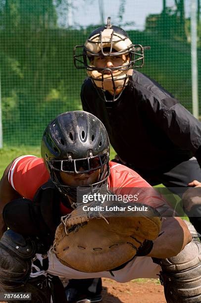 a baseball catcher and an umpire at a game - baseball umpire stock pictures, royalty-free photos & images