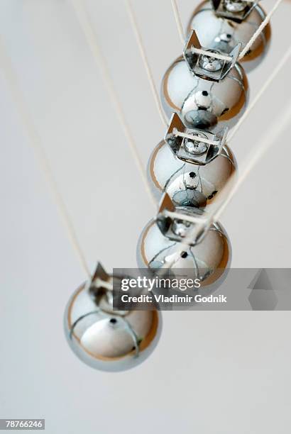 close-up of newton's cradle desk toy - perpetual motion stock pictures, royalty-free photos & images