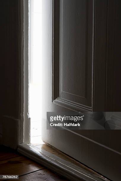 light shining through a door left ajar - magic doors stock pictures, royalty-free photos & images