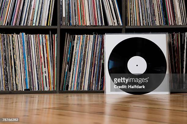 records leaning against shelves - vinyl records stock-fotos und bilder