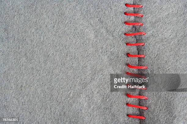 red stitching on gray fabric - zoom in stockfoto's en -beelden
