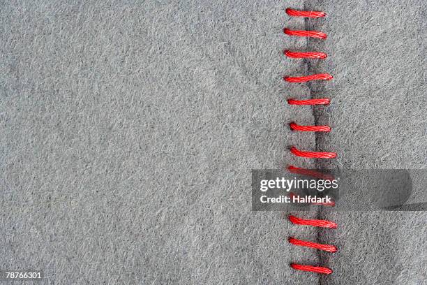 red stitching on gray fabric - repairing clothes stock pictures, royalty-free photos & images