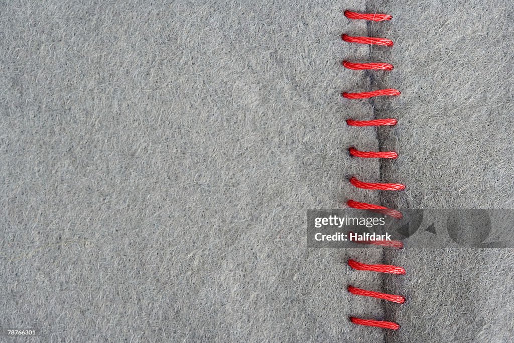 Red stitching on gray fabric