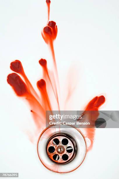 blood washing down a plughole - blood in sink stockfoto's en -beelden