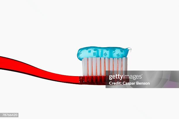 toothbrush with blue toothpaste - toothpaste stock pictures, royalty-free photos & images