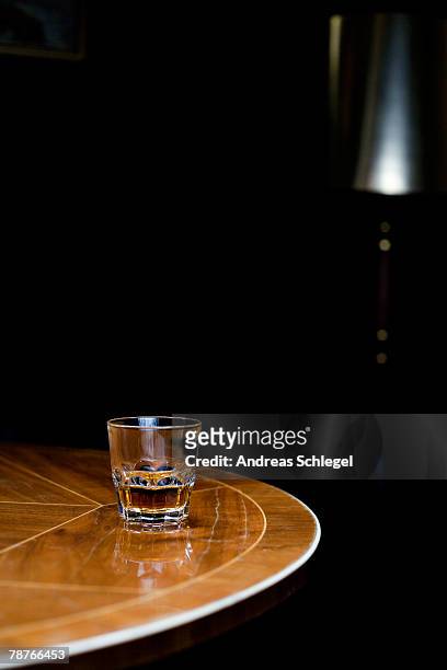a glass of whiskey on a table - art deco furniture fotografías e imágenes de stock