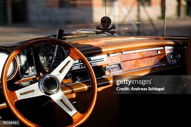 steering wheel and dashboard of a vintage car - luchtverfrisser stockfoto's en -beelden