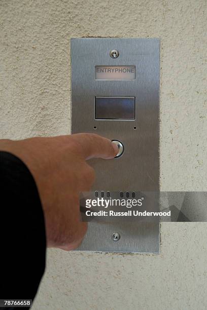 detail of a man pressing an intercom button - citofono foto e immagini stock