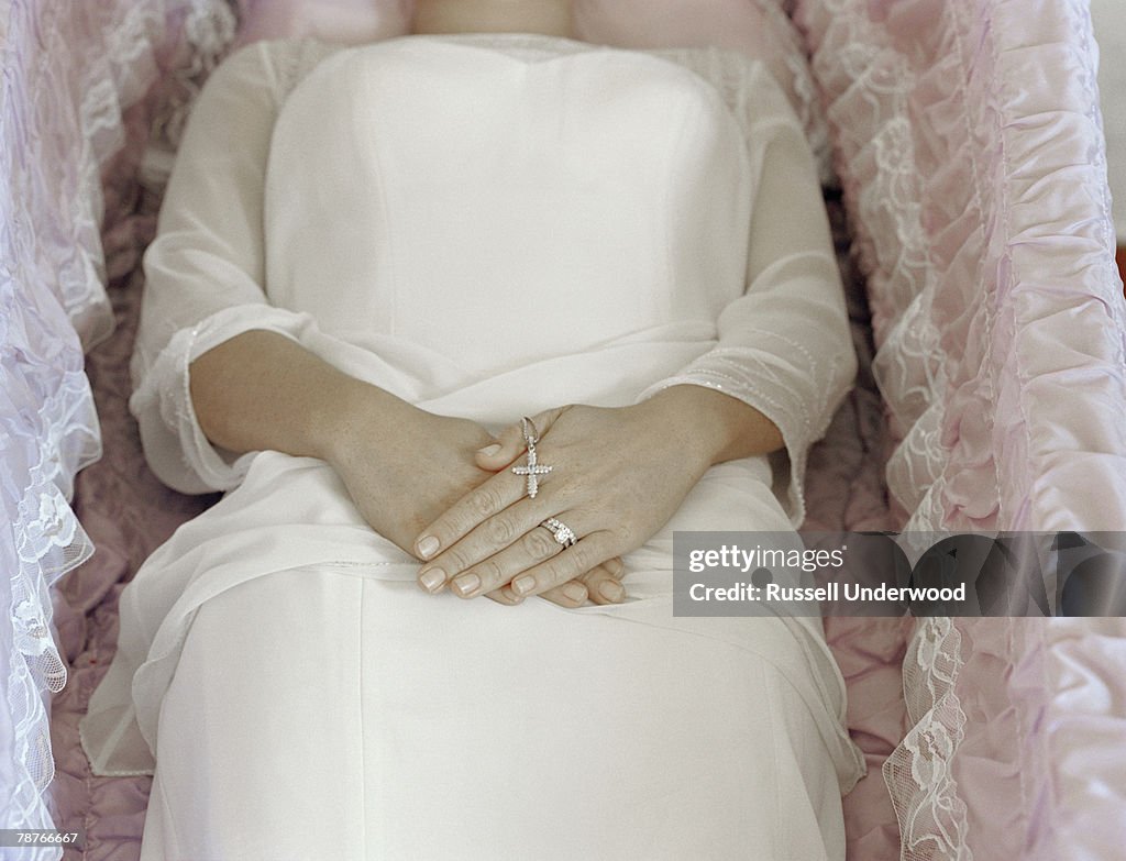 A woman lying in a coffin
