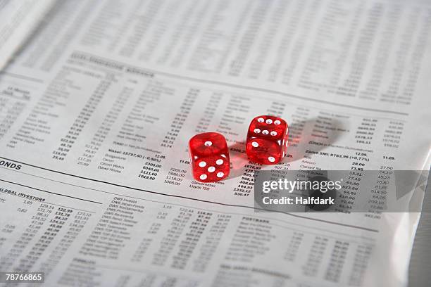 two dice on a newspaper - financial newspaper stock pictures, royalty-free photos & images
