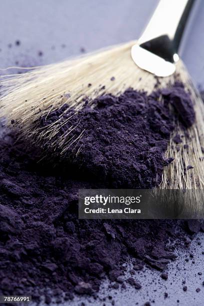 a make-up brush with purple eyeshadow - purple eyeshadow stock pictures, royalty-free photos & images